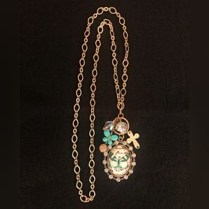 Gold colored necklace with butterfly pendant surrounded by 13 round crystals.